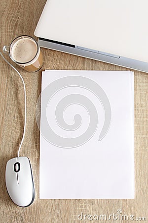 A4 blank white pperon table with laptop and mouse Stock Photo