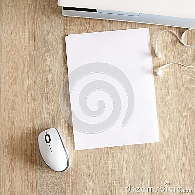 A4 blank white pperon table with laptop and mouse Stock Photo
