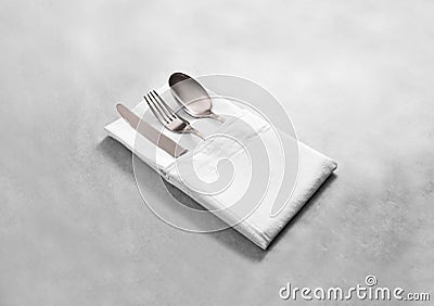 Blank white restaurant cloth napkin mock up with silver cutlery Stock Photo