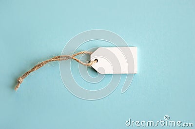 Blank white wooden price tag or label isolated on light blue background Stock Photo