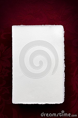 Blank White Writing Paper over Rich Red Background Stock Photo