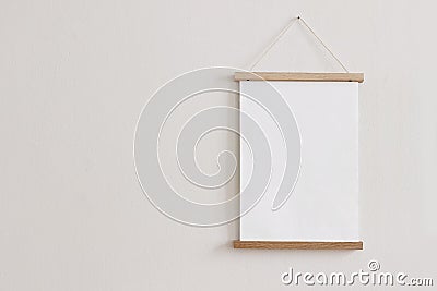 Blank wooden picture frame hanging on beige wall. Empty poster mockup for art display. Minimal interior design.Front Stock Photo