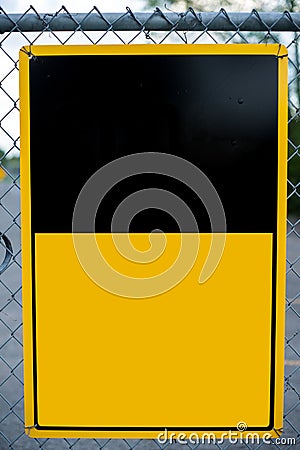 Blank Yellow Sign on Chain-Link Fence Stock Photo