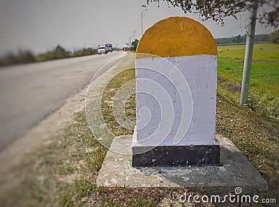 A blank yellow and white color milestone on the international highway Stock Photo