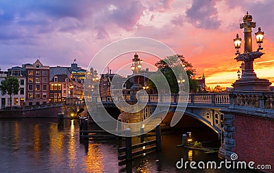Blauwbrug Blue Bridge over Amstel river in Amsterdam at sunset spring evening, Holland. Stock Photo