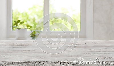 Bleached vintage wooden tabletop with blurred window for product display Stock Photo