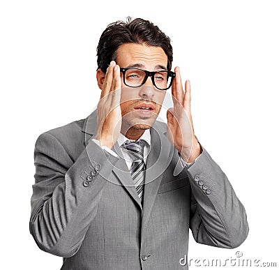 My brain is asleep. A bleary-eyed young executive putting his glasses on while isolated on a white background. Stock Photo
