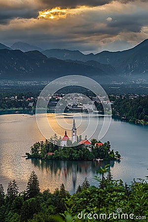 Bled, Slovenia - Golden sky and clouds above Lake Bled Blejsko Jezero with the Pilgrimage Church of the Assumption of Maria Stock Photo