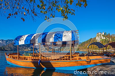 Bled, Slovenia - Traditional blue Pletna boat in the autumn sunshine at Lake Bled Stock Photo