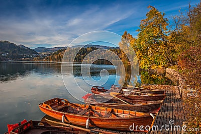 Bled, Slovenia - Traditional Slovenian boats by Lake Bled with colorful autumn trees Stock Photo