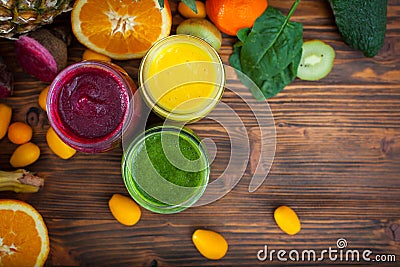 Blended green, yellow and purple smoothie with ingredients Stock Photo