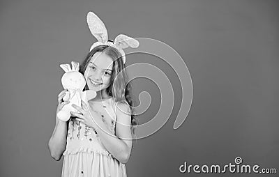 A blessed Easter. Easter bunny rabbit. Small child with cute toy. Little child in Easter rabbit style playing with toy Stock Photo