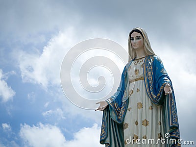 The Blessed Virgin Mary Statue blue sky background Stock Photo