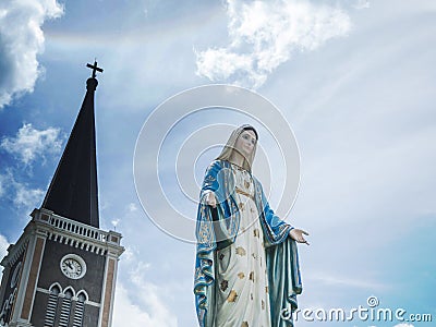 The Blessed Virgin Mary Statue blue sky background. Stock Photo