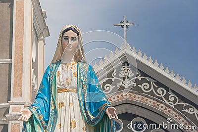 The Blessed Virgin Mary statue standing in front of The Cathedral of the Immaculate Conception at The Roman Catholic Diocese. Stock Photo