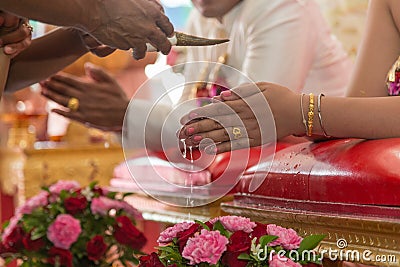 Blessed water poured out in thai wedding ceremony Stock Photo