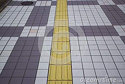 Blind floor tiles on public walkway Stock Photo