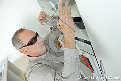 Blind man alone in kitchen Stock Photo