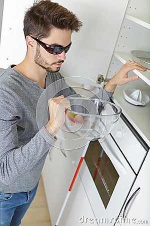 Blind man in kitchen Stock Photo