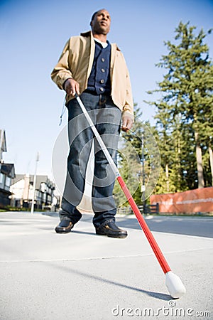 Blind man using a walking stick Stock Photo