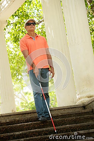 Blind Man Walking And Descending Stairs In City Park Stock Photo