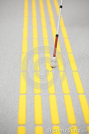 Blind pedestrian walking on tactile paving Stock Photo