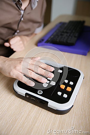 Blind person using audio book player for visually impaired Stock Photo