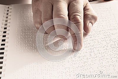 Blind reading text in braille language Stock Photo