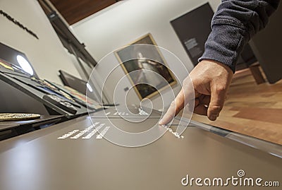 Blind reading text caption in braille language at museum Editorial Stock Photo