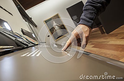 Blind reading text caption in braille language at museum Editorial Stock Photo