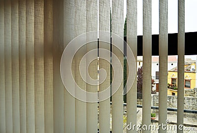 Blinds with adjustable vertical slats made of fireproof fabric to regulate ambient light Stock Photo