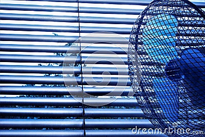 Blinds and fan is an effective protective device against the summer heat. The slats of the blinds to turn and regulate the light Stock Photo