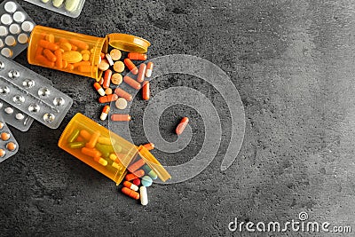 Blister packs and containers with pills on grey background Stock Photo
