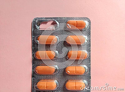 Blister of pills on pink background. medical concept Stock Photo