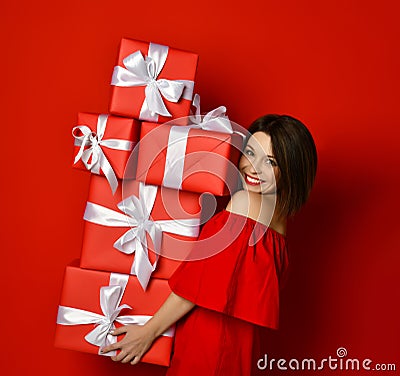 Blithesome birthday girl in dress posing with presents Stock Photo
