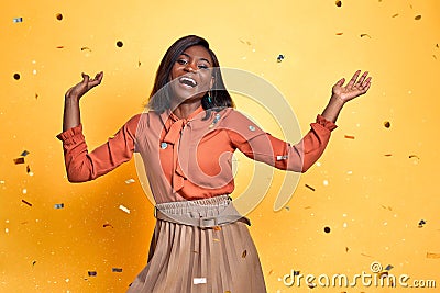 Blithesome girl celebrating her birthday and smiling. Indoor photo of african charming lady isolated on yellow background Stock Photo