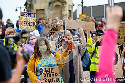 BLM protesters wear PPE Face Masks and hold homemade signs at a Black Lives Matter protest in Richmond, North Yorkshire Editorial Stock Photo