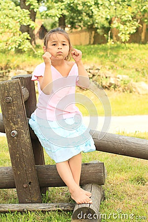 Bloated girl sitting on wooden construction Stock Photo