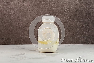Bloated packaging, expired dairy product. Sour milk or kefir in swollen bottle. Concept - Improper storage of food. Spoiled, Stock Photo