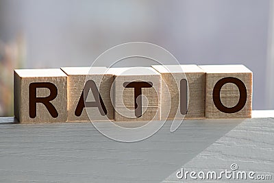 Block of alphabet letters forming the word RATIO on wooden surface. Concept of common marketing business terms. Slightly defocused Stock Photo