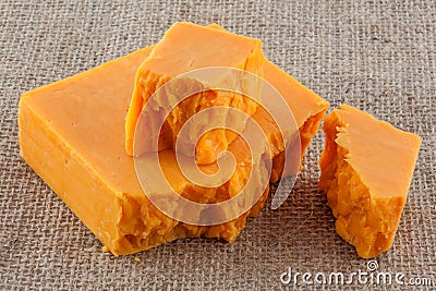 Block hard red cheddar cheese. Stock Photo
