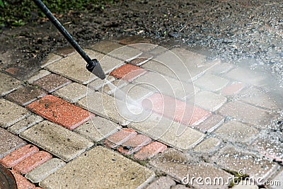 Block paving cleaning with high pressure washer Stock Photo