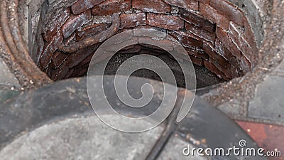 Blocked sewer drain. The water of recycling. Uninstalling septic tank with old iron manhole. Stock Photo
