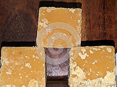 Blocks of Indian jaggery isolated on Wooden background Stock Photo