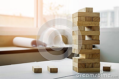 the blocks wood tower game with architectural engineer plans or Stock Photo