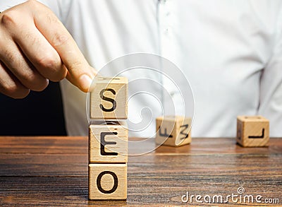 Blocks with the word SEO and businessman. Search Engine Optimization. Increase the quality and quantity of website traffic by Stock Photo