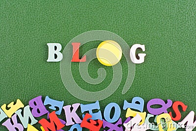 BLOG word on green background composed from colorful abc alphabet block wooden letters, copy space for ad text. Learning Stock Photo