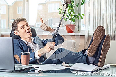 Blogger businessman recording vlog video in office. Concept of social marketing and business training Stock Photo