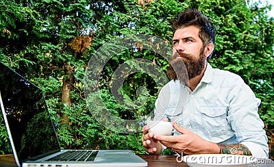 Blogger freelance editor. Workaholic stereotype. Drink coffee work faster. Bearded man freelance worker. Remote job Stock Photo