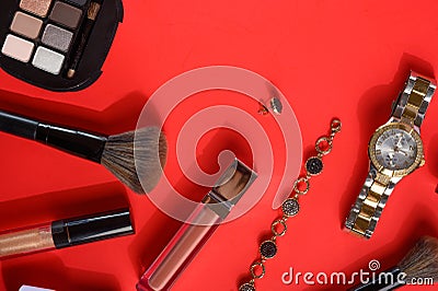 Blogging Beauty Concept. Professional women`s cosmetics, accessories, watches, bracelet. Female ideas and background. Red Stock Photo